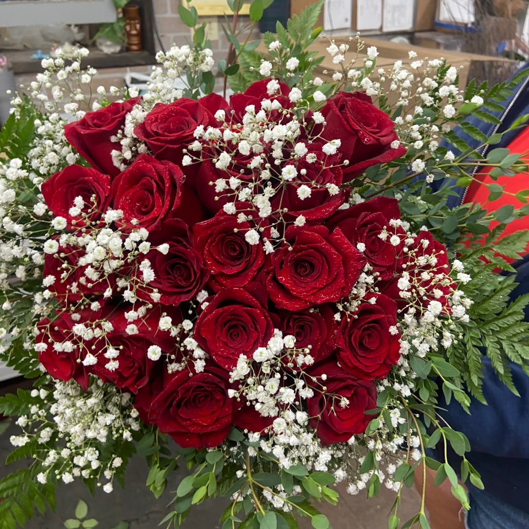 Bouquet of red roses with white baby's breath and greenery