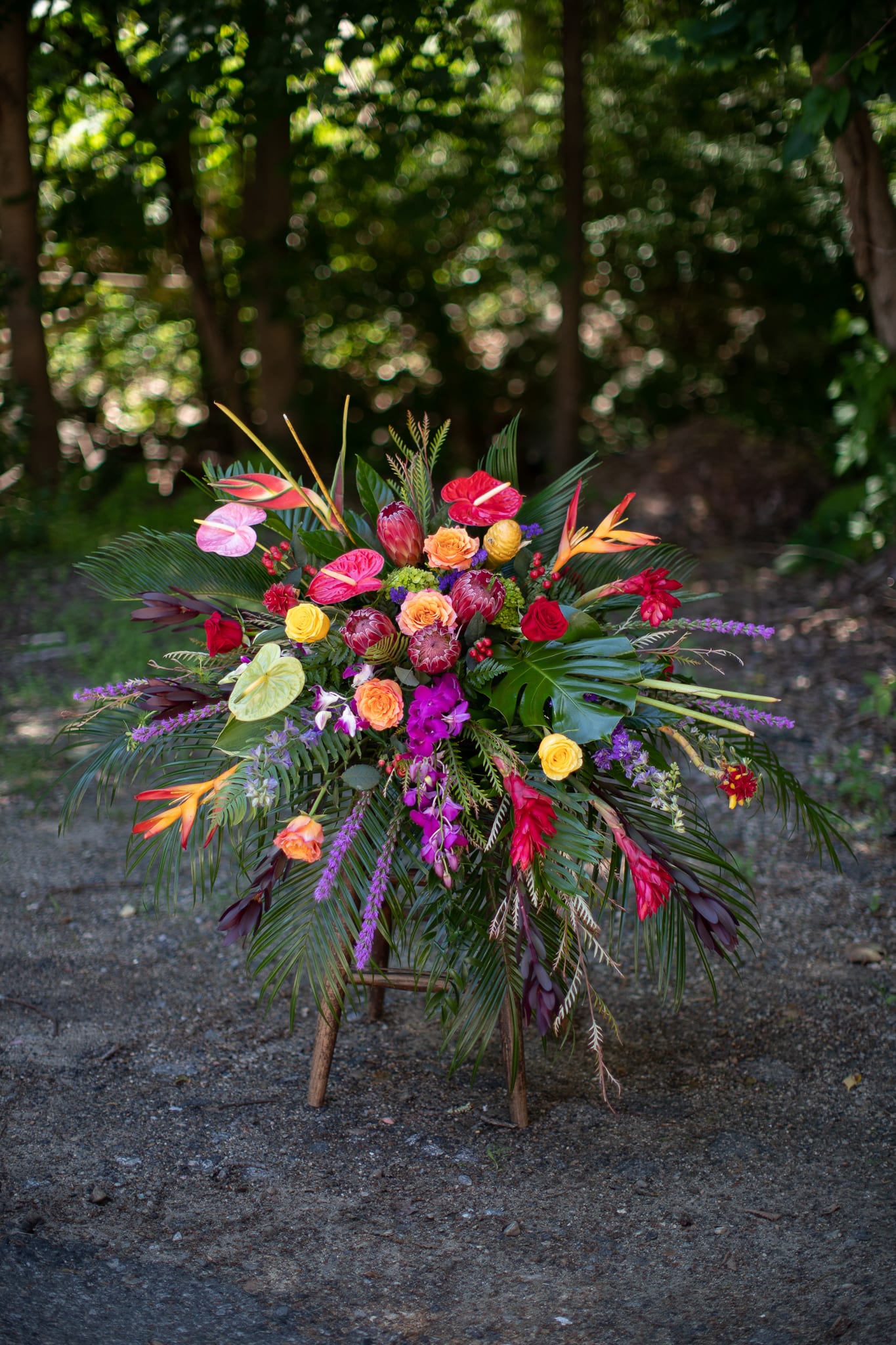 Tropical floral arrangement with red, pink, orange, and purple blooms