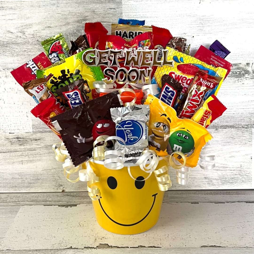 Candy bouquet in a yellow smiley-face bucket with curled ribbons