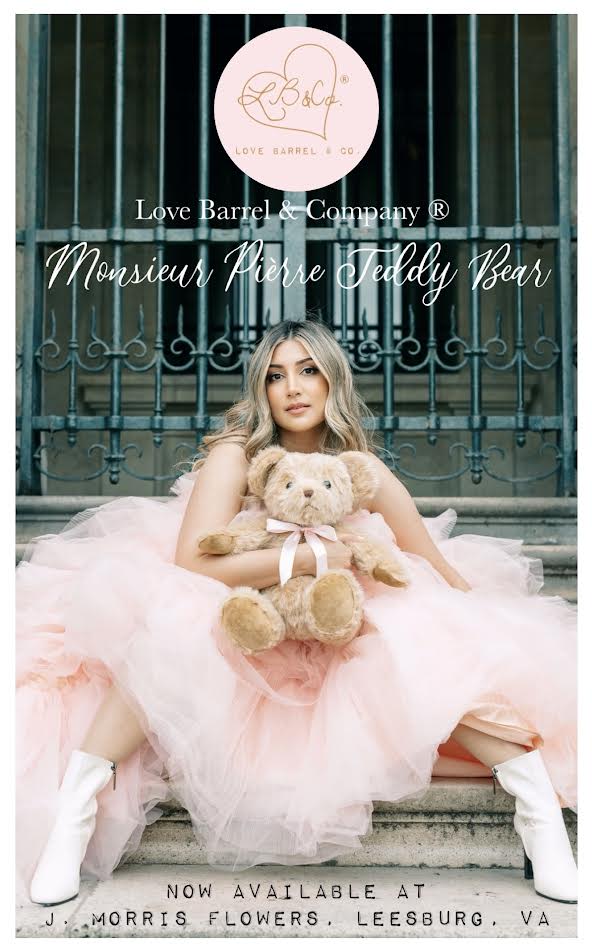 Woman in a pink dress holding a teddy bear with brand text overlaid