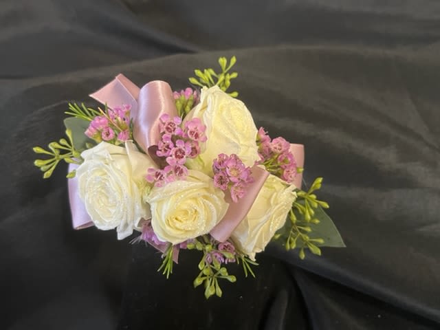 Bouquet of white roses with pink filler flowers and satin ribbon
