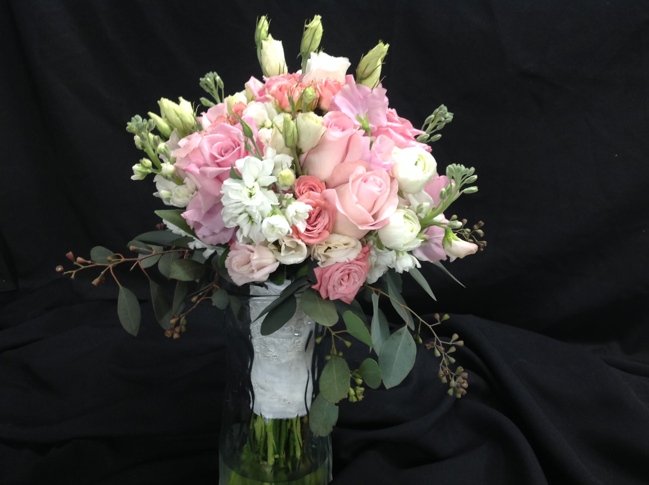 Pink and white bouquet in a clear glass vase