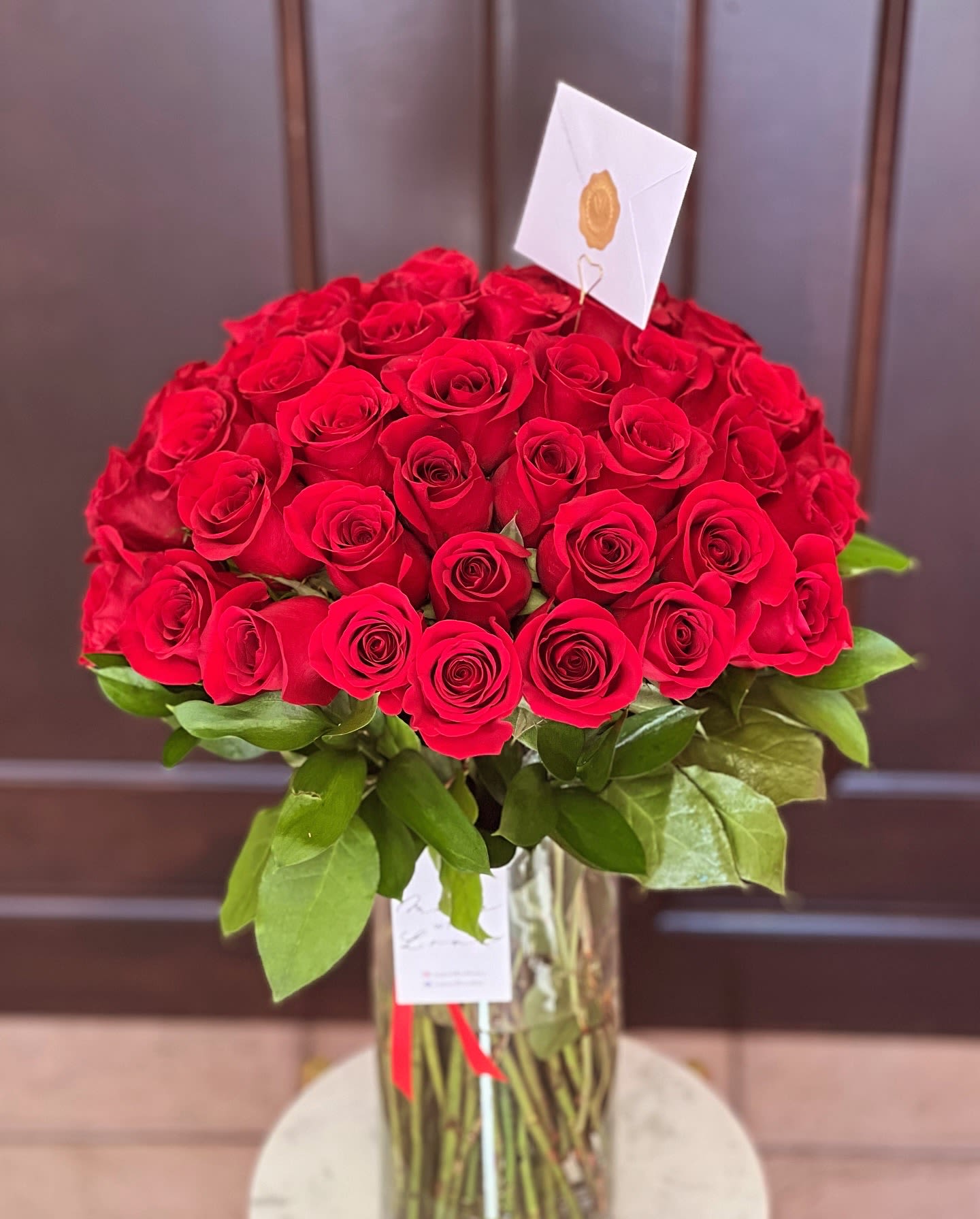 Large bouquet of red roses in a glass vase