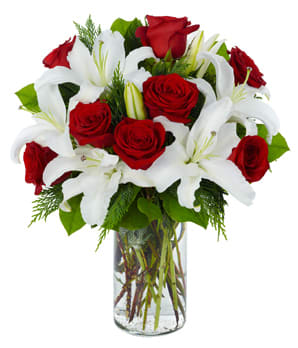 Red roses and white lilies in a clear glass vase