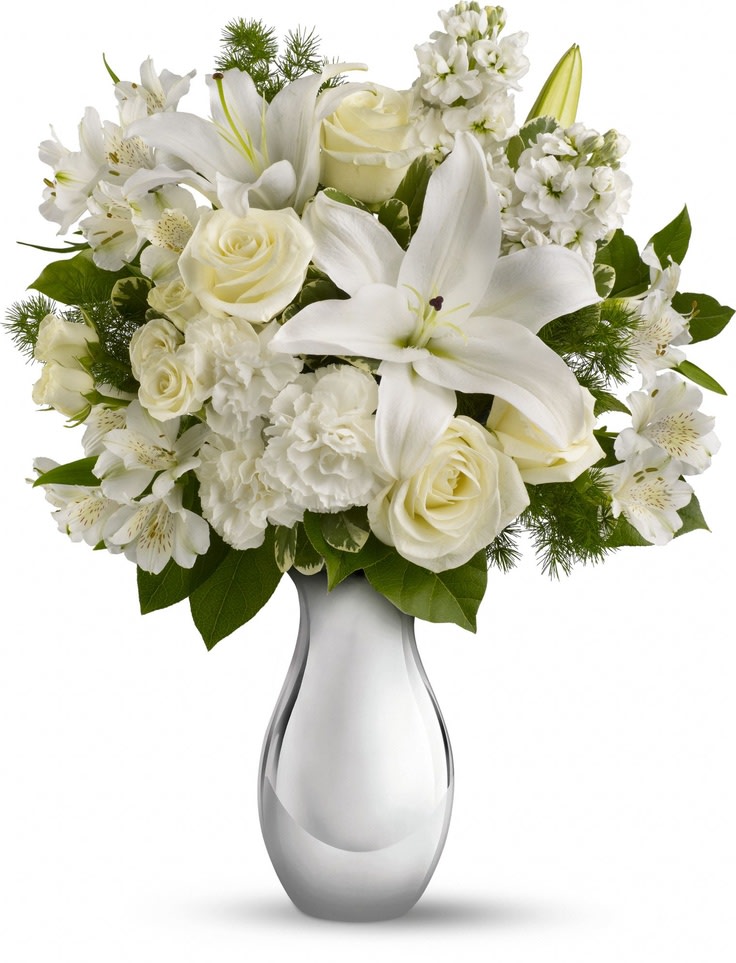 White lilies and roses arranged in a glass vase
