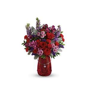 Red and purple mixed bouquet in a red vase with a heart pendant
