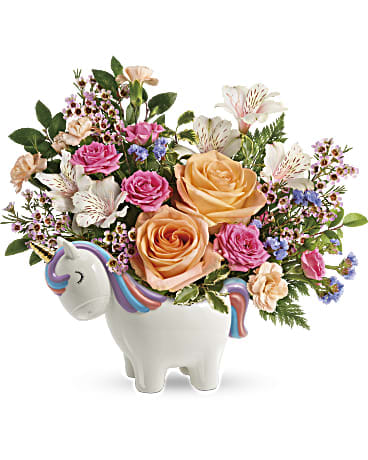 Bouquet of pink and peach roses in a unicorn-shaped vase