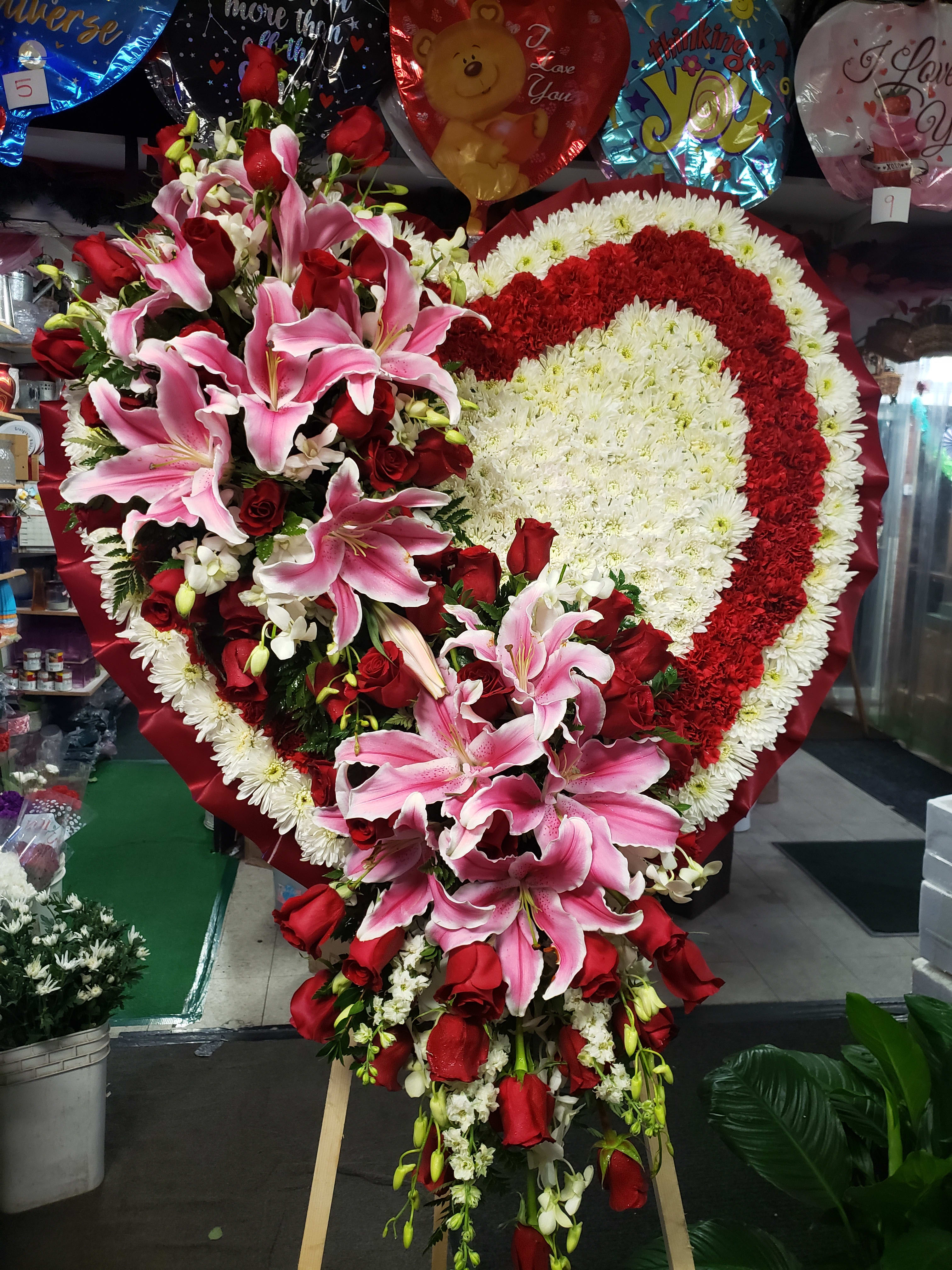 Heart-shaped floral spray with pink lilies and red roses