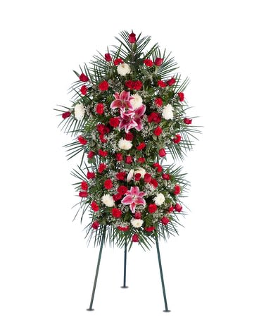 Standing funeral spray with red and white flowers on a tripod easel