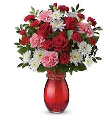 Red and pink mixed bouquet in a red glass vase