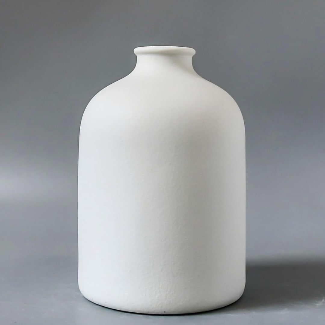 White ceramic vase on a gray background