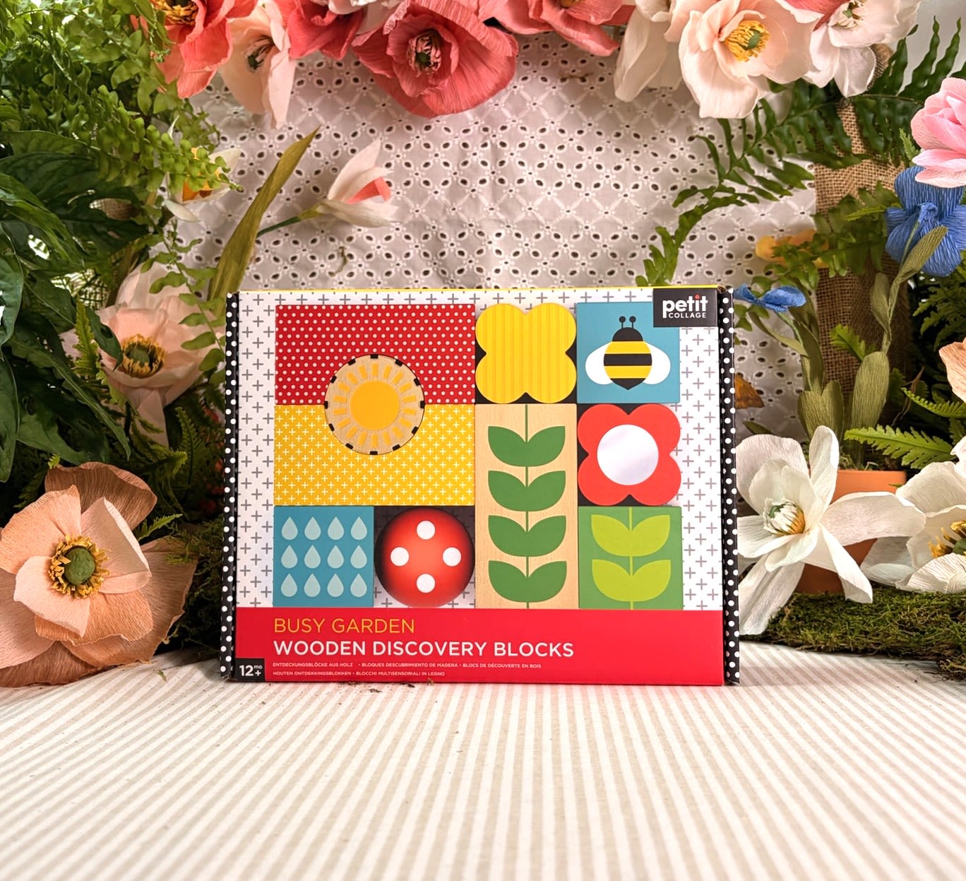 Busy Garden - Wooden Discovery Blocks - Explore the wonders of nature with these garden-themed discovery blocks! This delightful set of 10 wooden sensory blocks feature a variety of engaging elements, including a mirror, chime bell, and textured debossing for a rich sensory experience. Crafted from FSC-certified wood, these blocks are not only safe but also environmentally friendly. Perfect for sparking curiosity and imaginative play!  Colour: Multi-coloured  Size: 14x5x14cm   Material Composition: Painted Wood/Paper/MDF/Plastic/Acrylic  Ages: 12m+