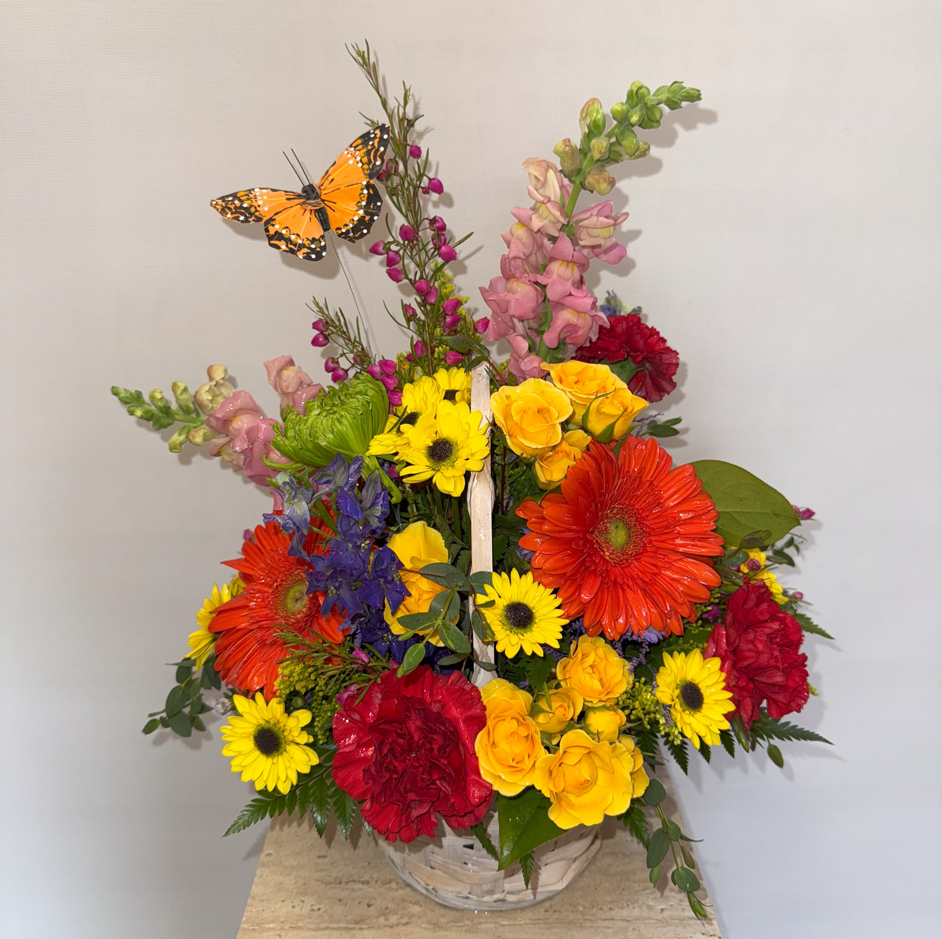 Spring Garden Basket - Mixed garden basket in a wicket basket with a variety of flowers and colors. 