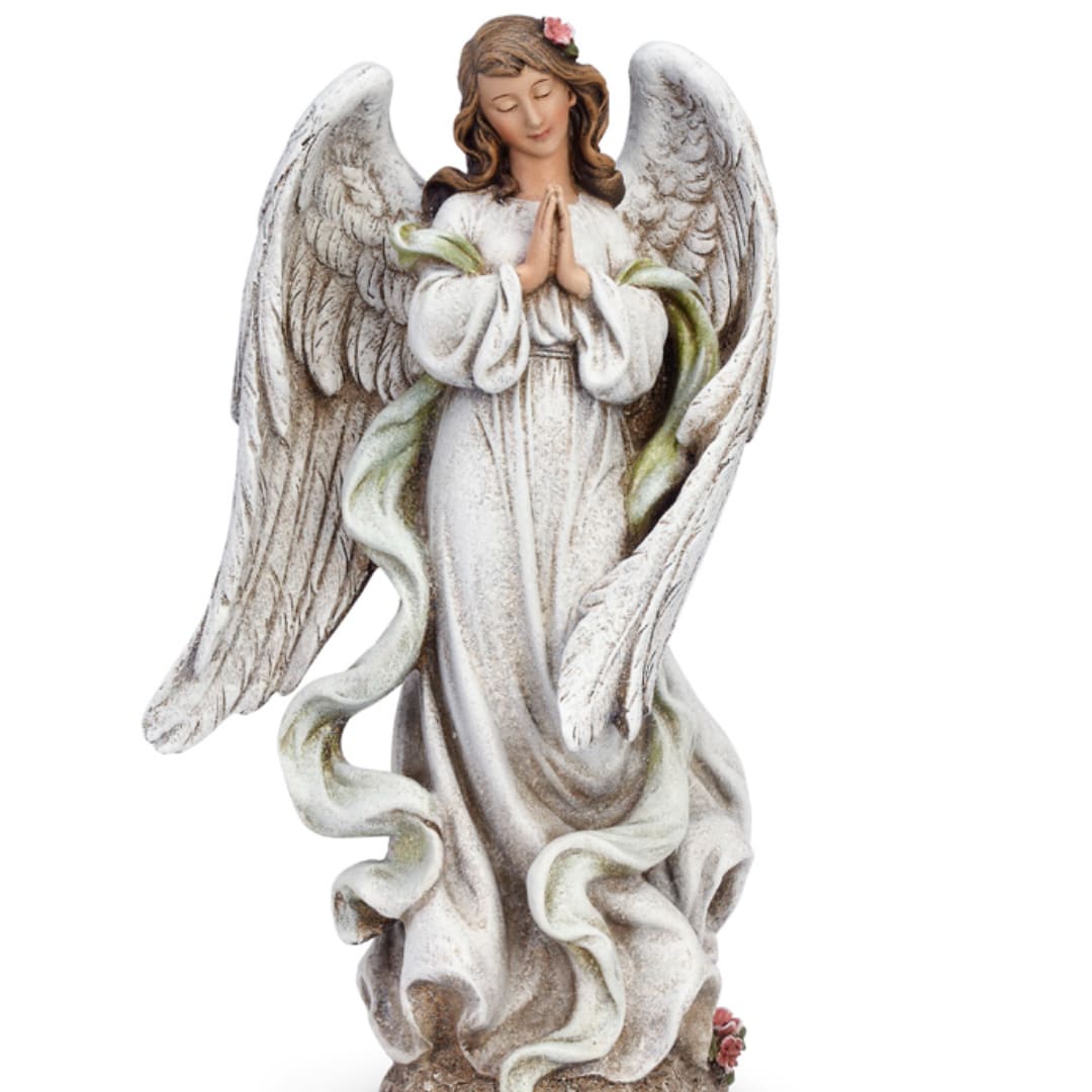 White angel statue with folded hands and a small pink flower on her head