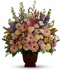 Large mixed bouquet in a brown urn vase with pink and cream flowers