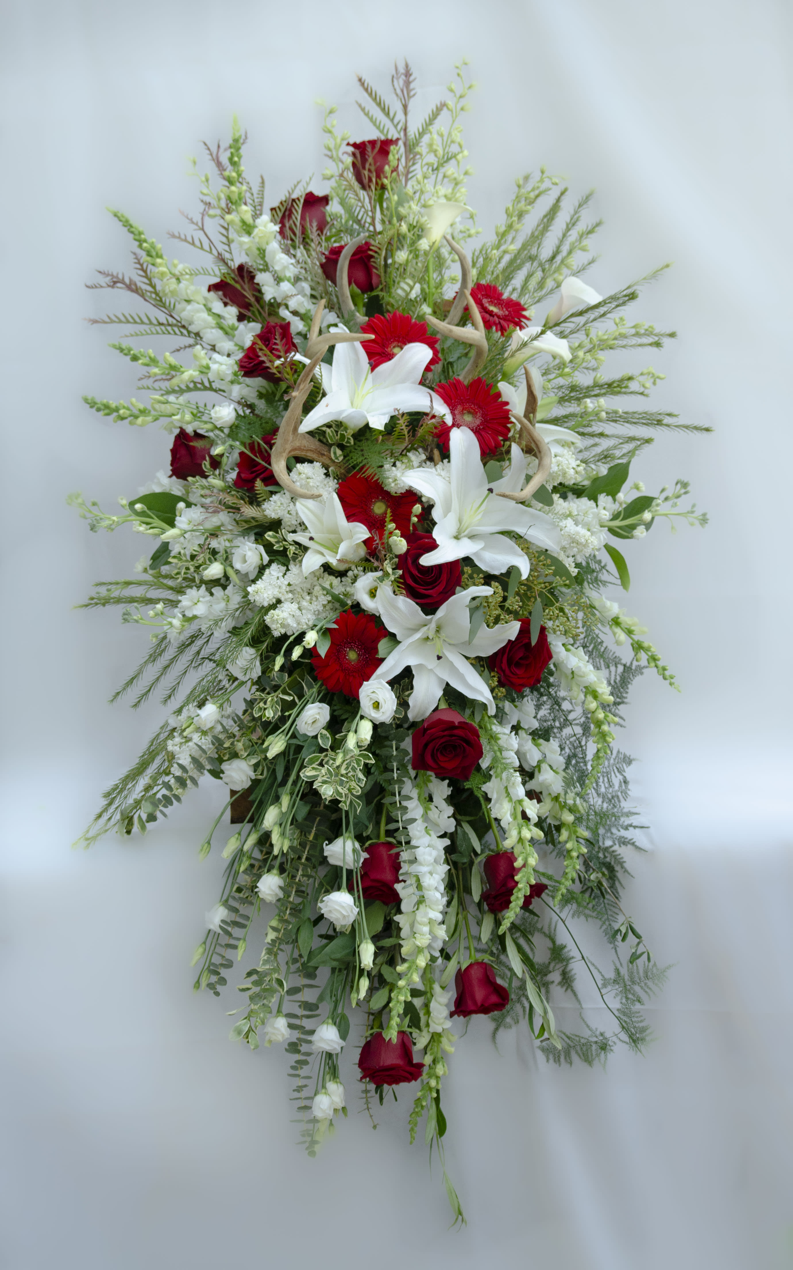Tall red and white floral spray with lilies and roses