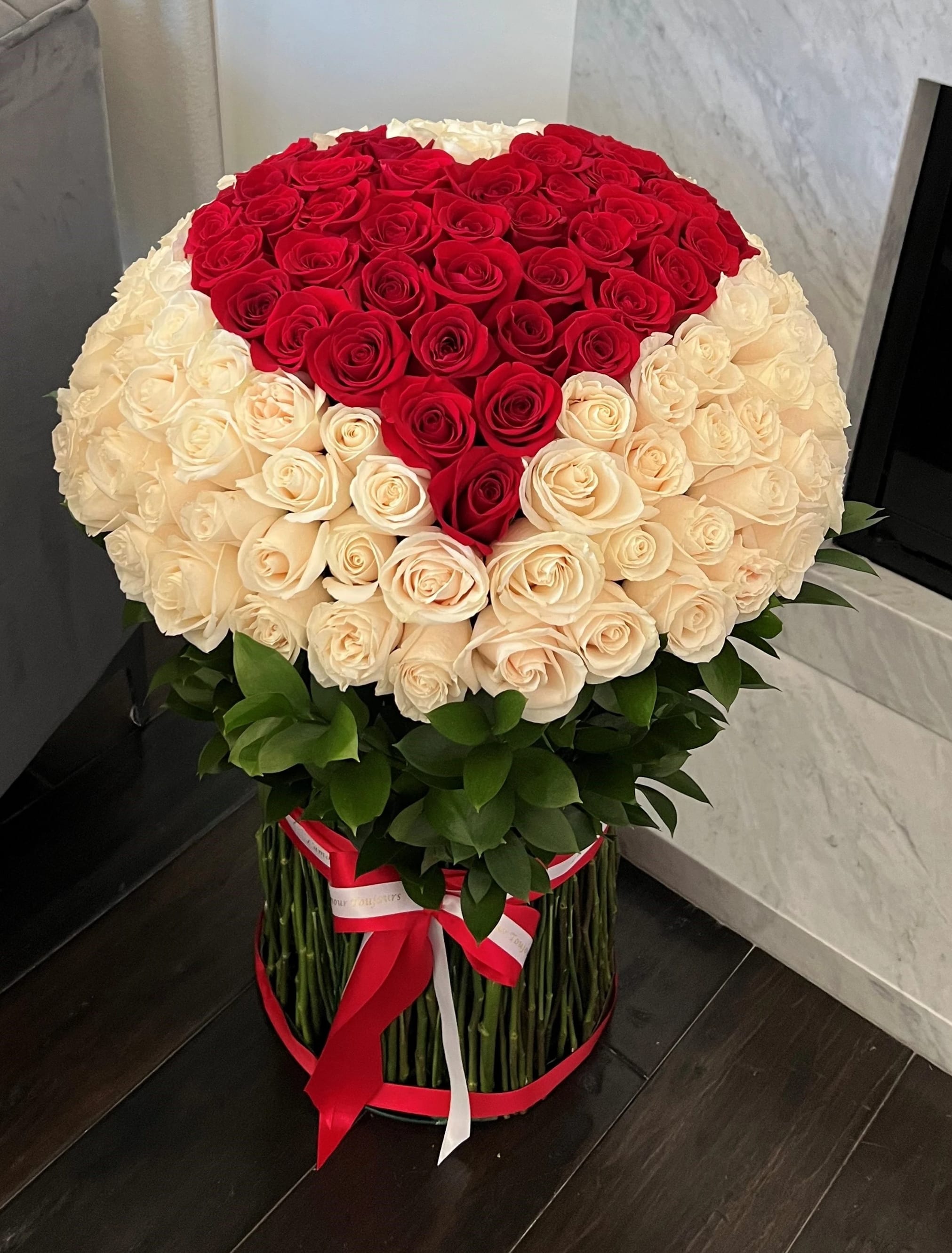 Large bouquet of red and cream roses in a round arrangement