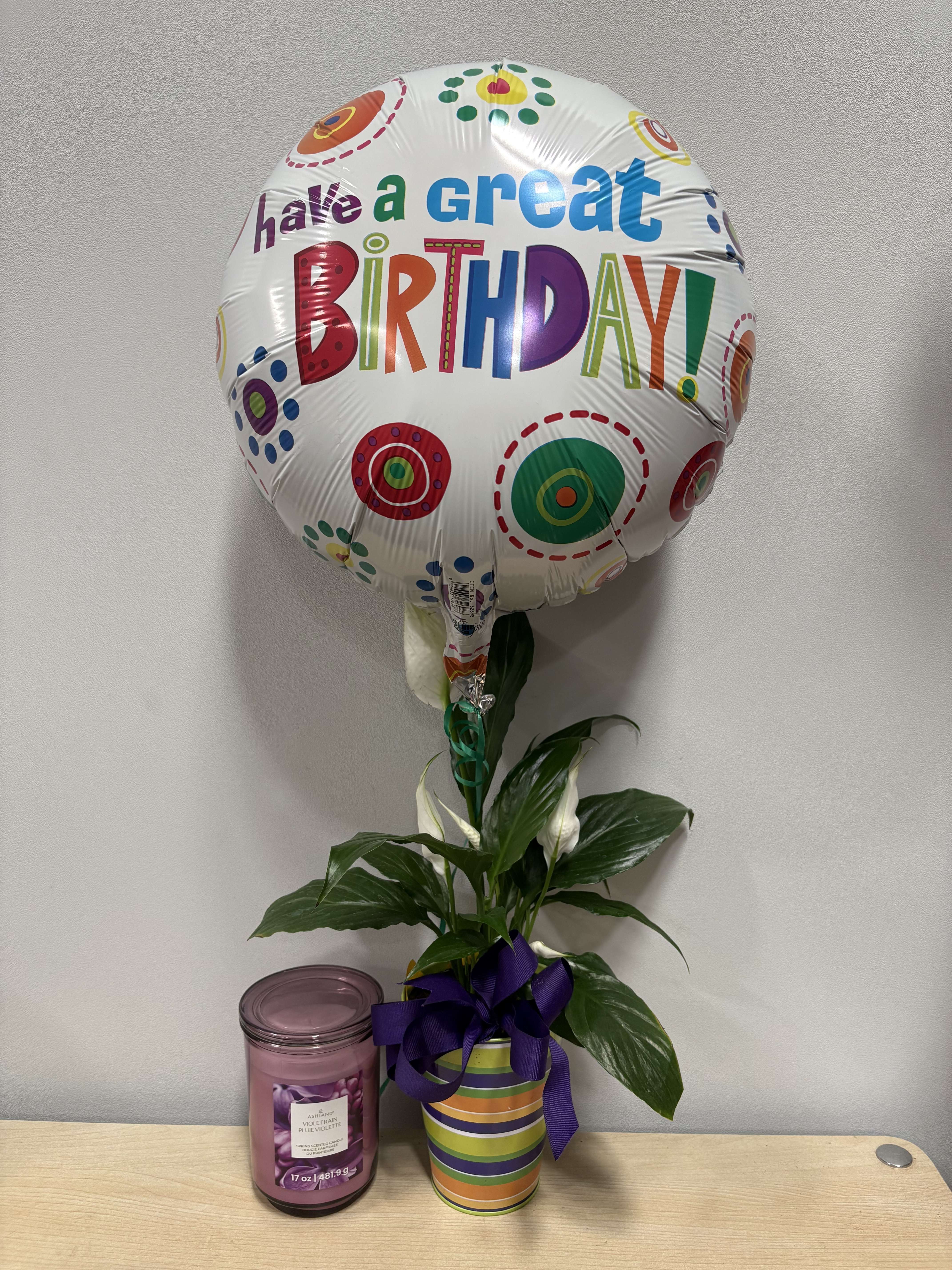 Birthday balloon with a potted peace lily and a candle