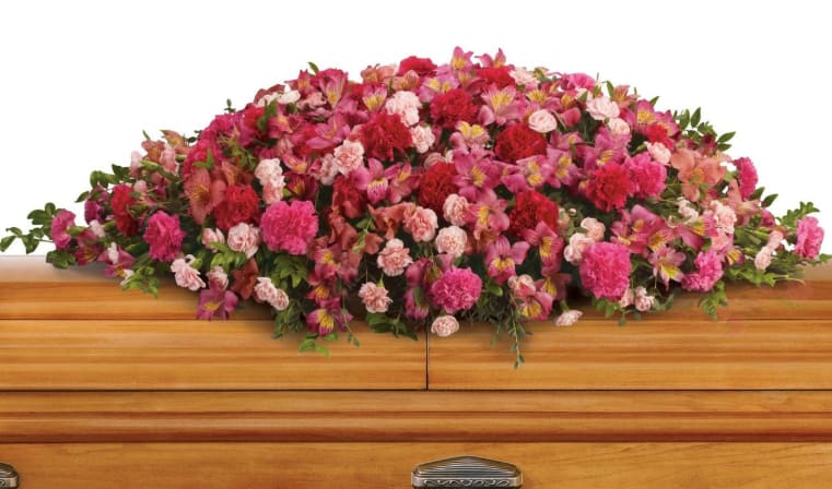 A Life Loved Casket Spray - As a tribute to a special person who has passed, this magnificent cascade of pink floral favorites is a radiant testament of profound and lasting love. 