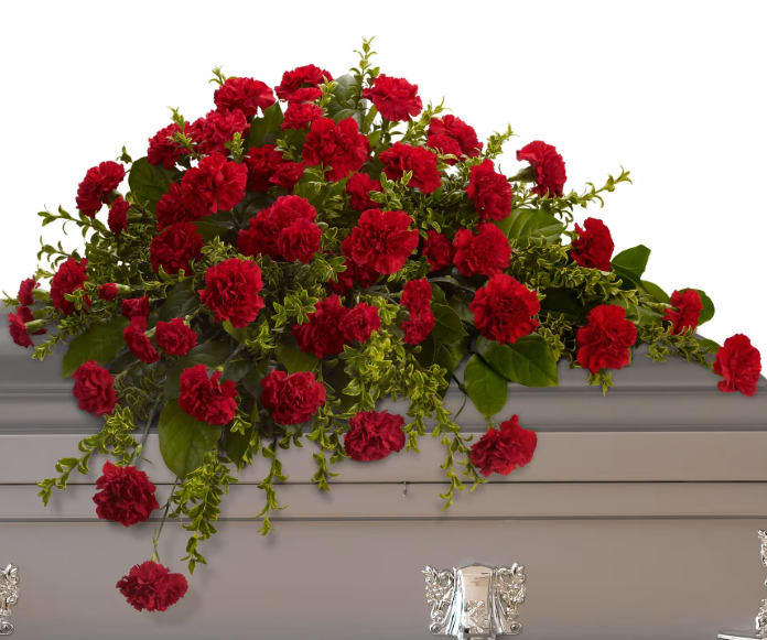 Adoration Casket Spray - This classic half-couch spray of brilliant red carnations makes a striking and dignified statement. Radiant red carnations and miniature carnations accented by fresh greenery arrive in a lovely spray.