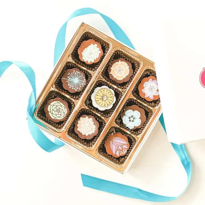 Flowers - Chocolate Covered Caramels - A mix of Milk and Dark Chocolate covering a soft creamy European style Vanilla Sea Salt Caramel.  Hand Sprinkled Fleur de Sel leaves a subtle crunch with the sweet caramel and bittersweet chocolate 