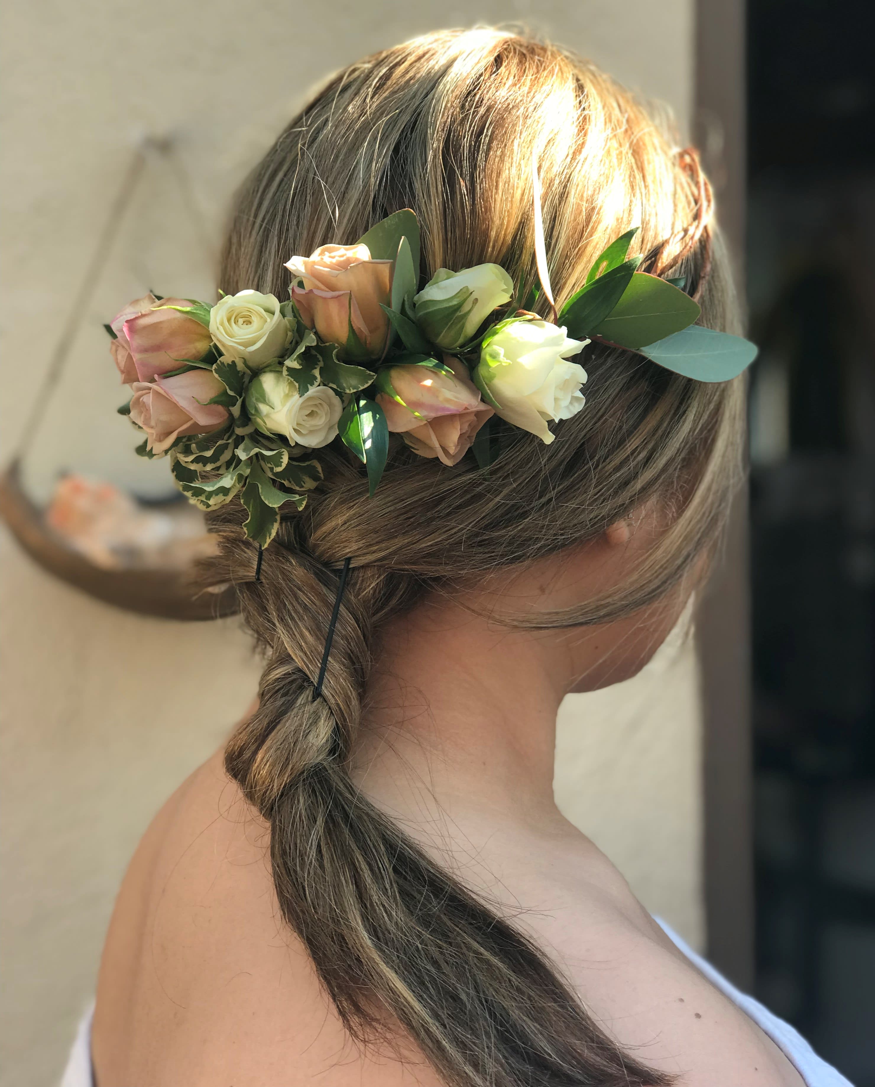 Woman wearing a floral crown of blush and cream roses