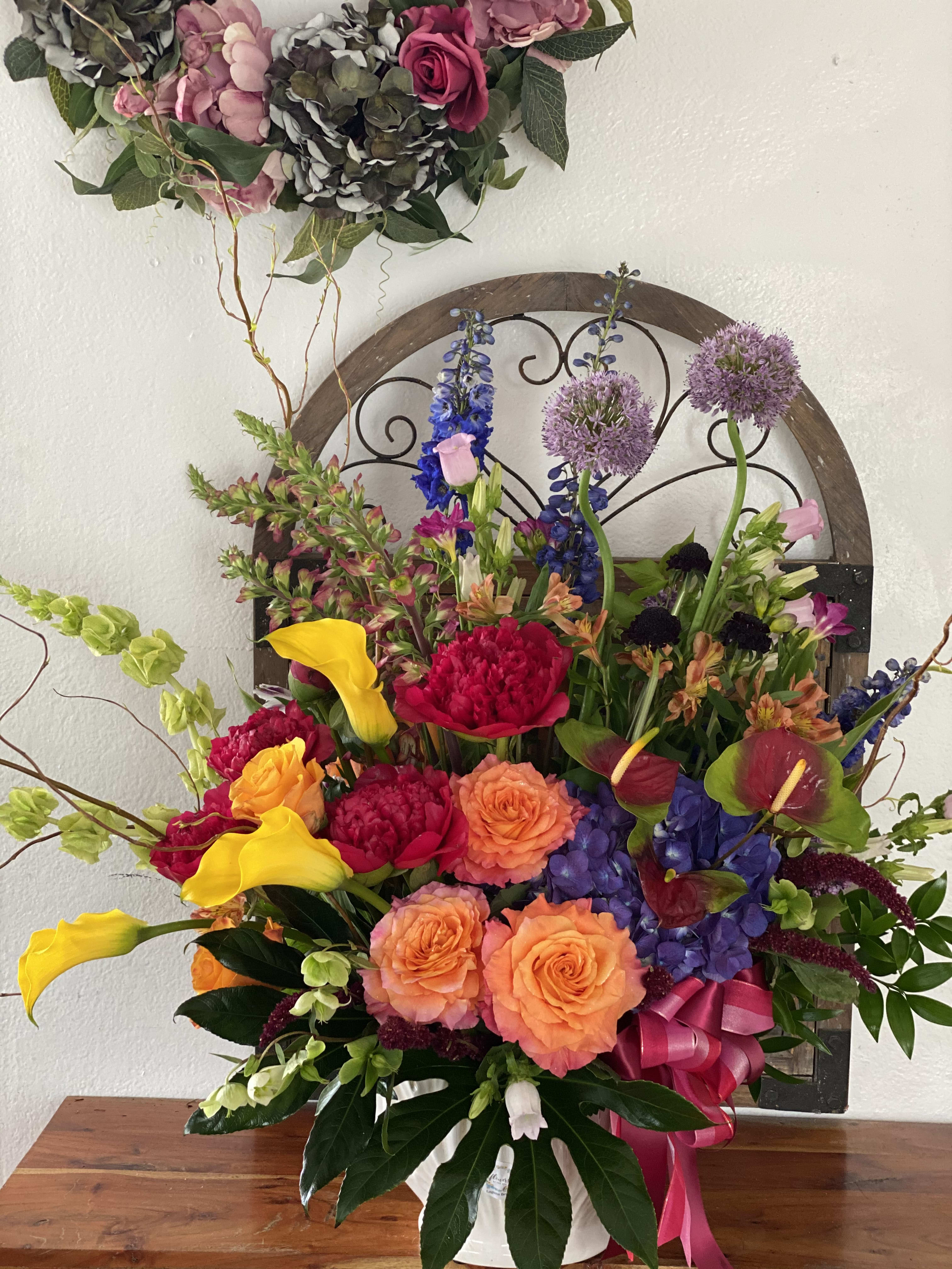 Colorful mixed flower arrangement with roses, calla lilies, and hydrangeas