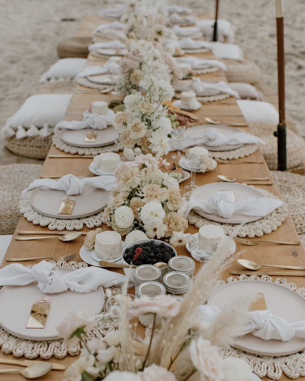 Long banquet table with white floral centerpieces and place settings