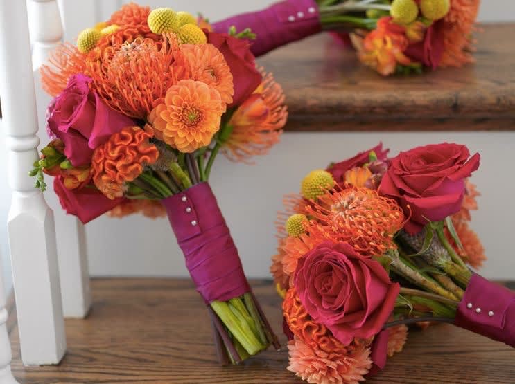 Two pink and orange bridal bouquets with roses and mums