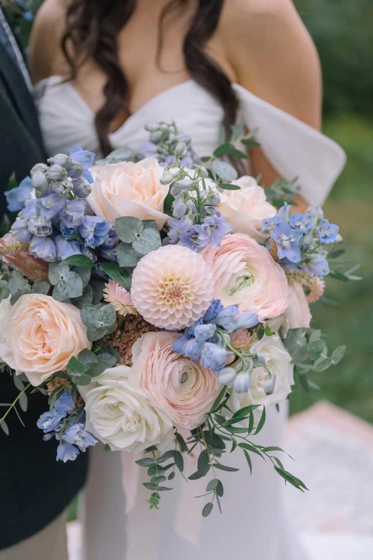 Wedding bouquet of blush, white, and blue flowers