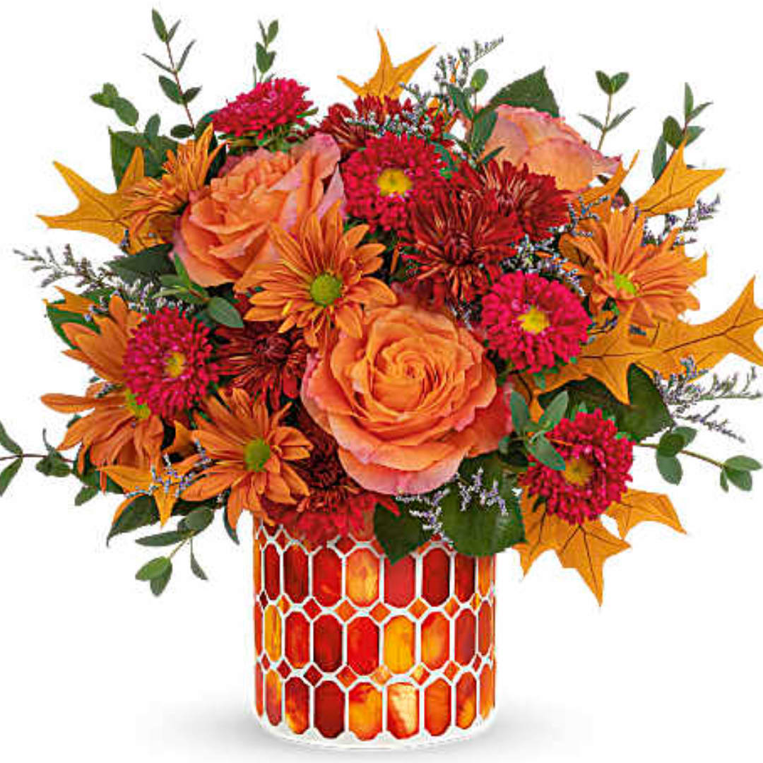 Orange and pink bouquet in a red mosaic vase