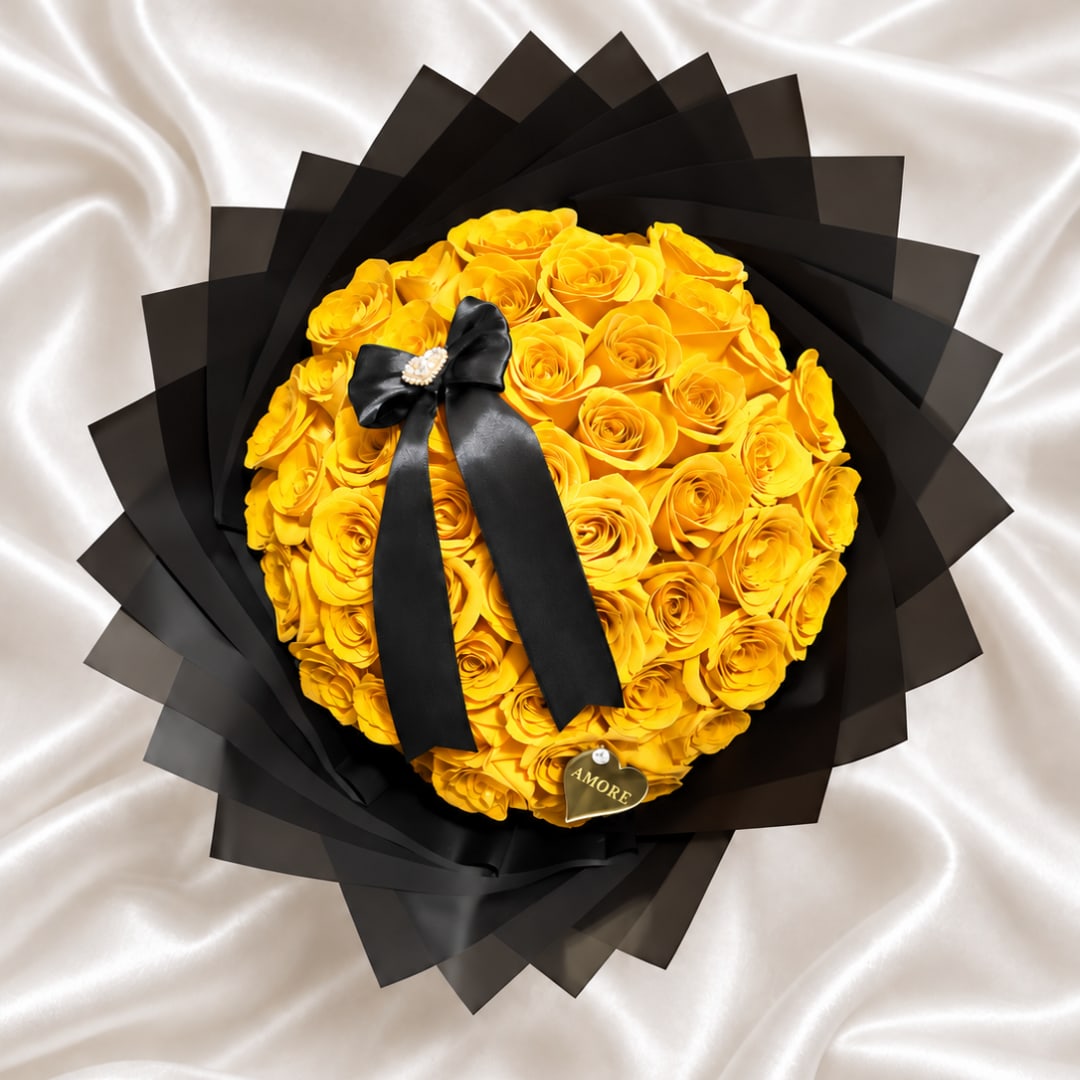 Round bouquet of yellow roses wrapped in black paper with a black ribbon