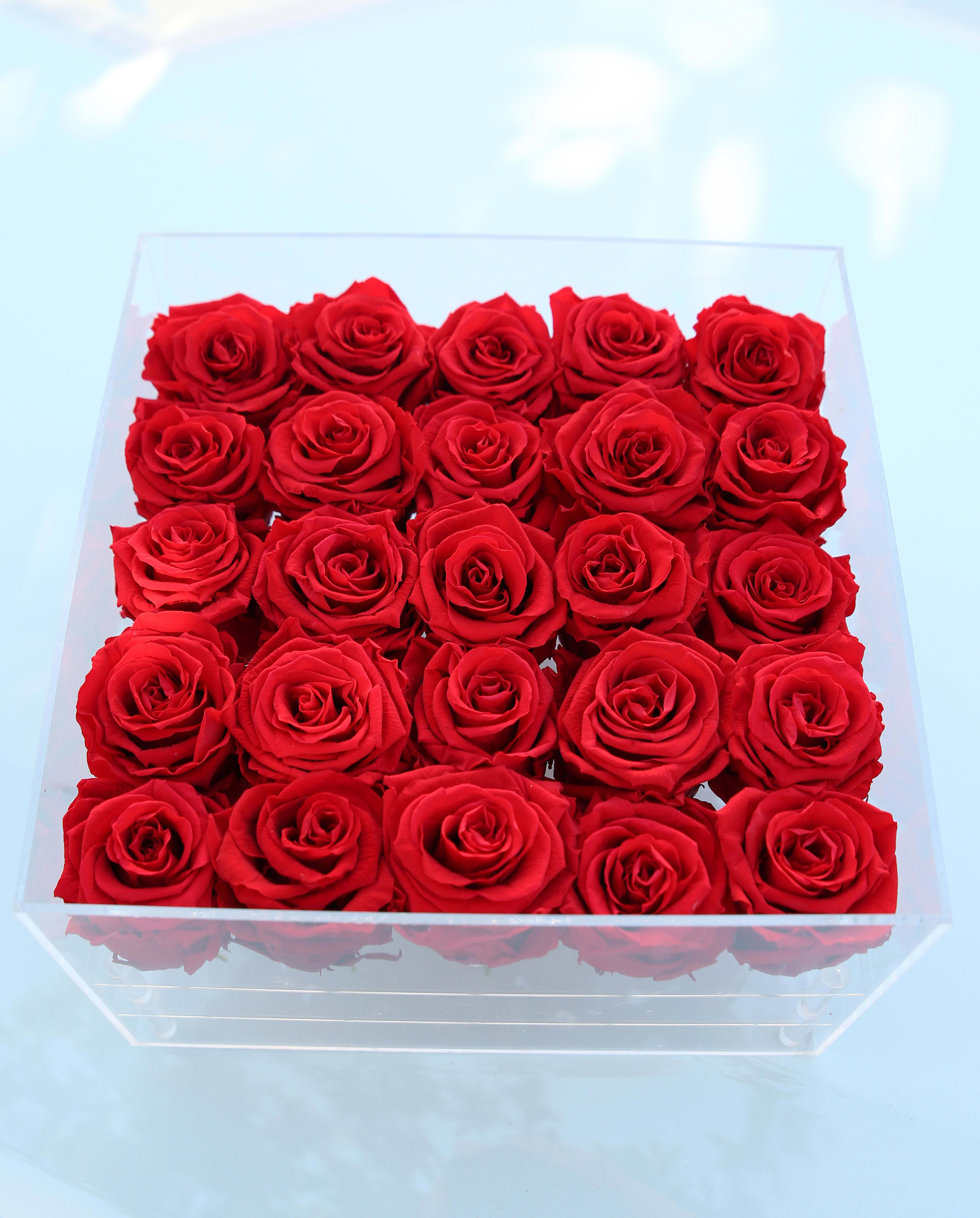 Box of red roses in a clear square container