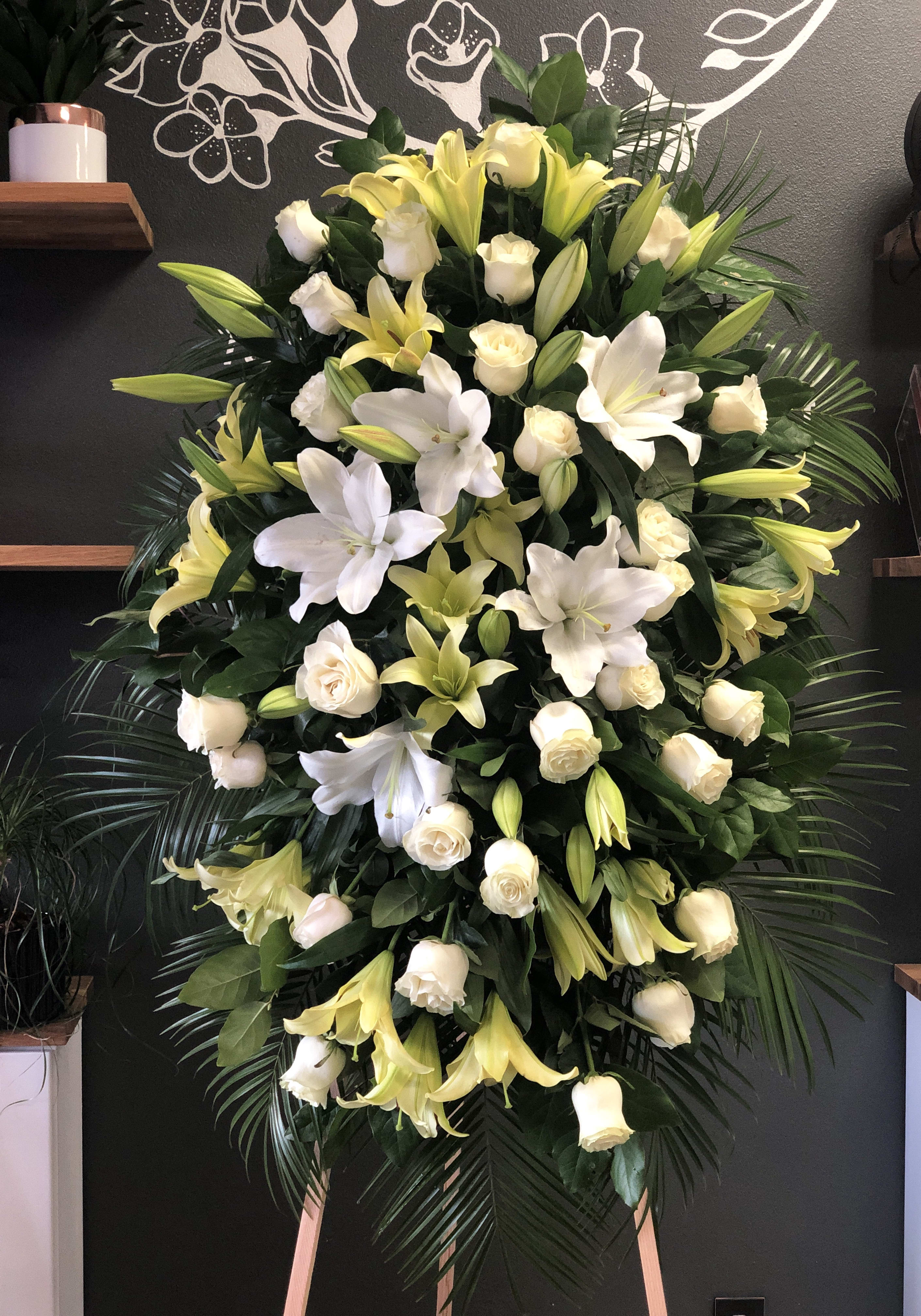 Large standing floral spray with white lilies and cream roses