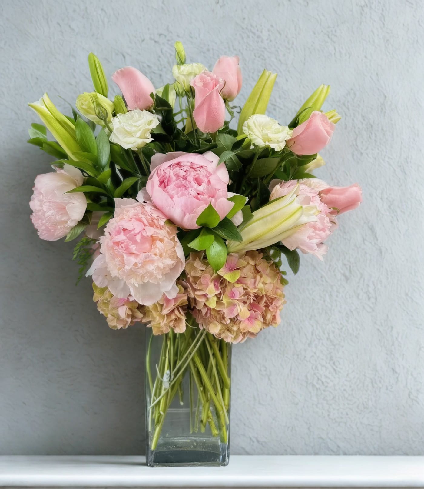 Pink and white bouquet in a clear glass vase