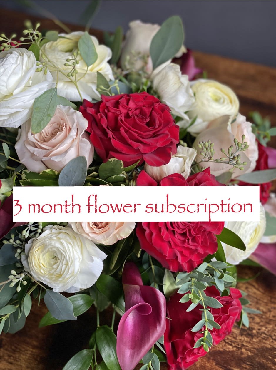 Bouquet of red, white, and blush roses with pink calla lilies
