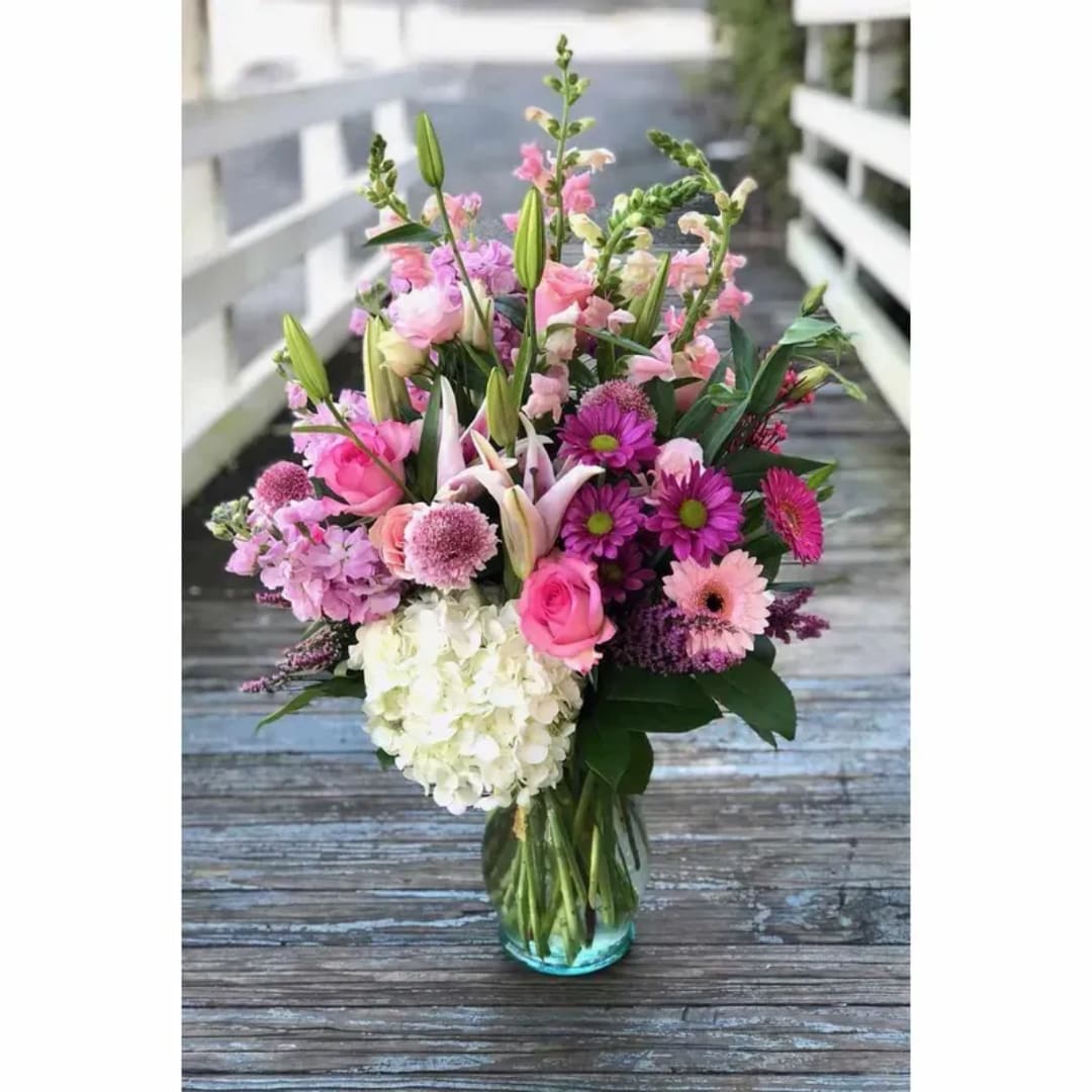 Pink and white mixed flower bouquet in a glass vase