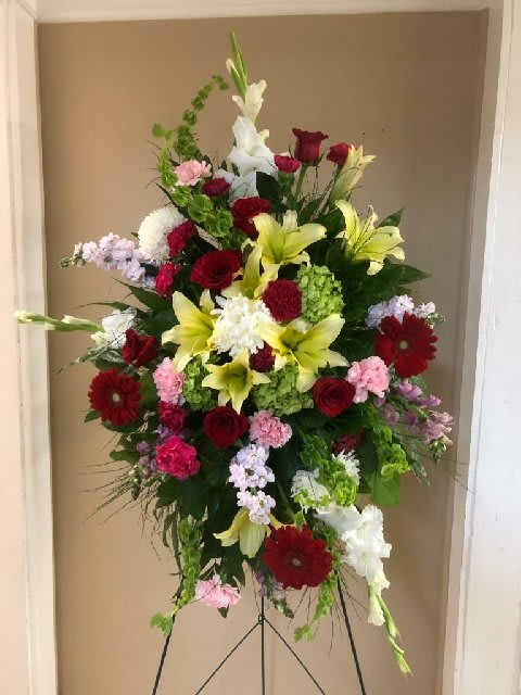 Tall mixed flower standing spray with red, white, pink, and yellow blooms