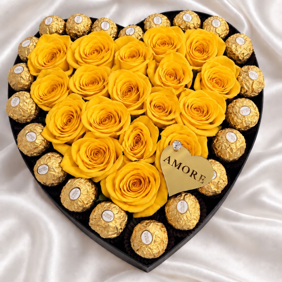Heart-shaped box with yellow roses and gold-wrapped chocolates