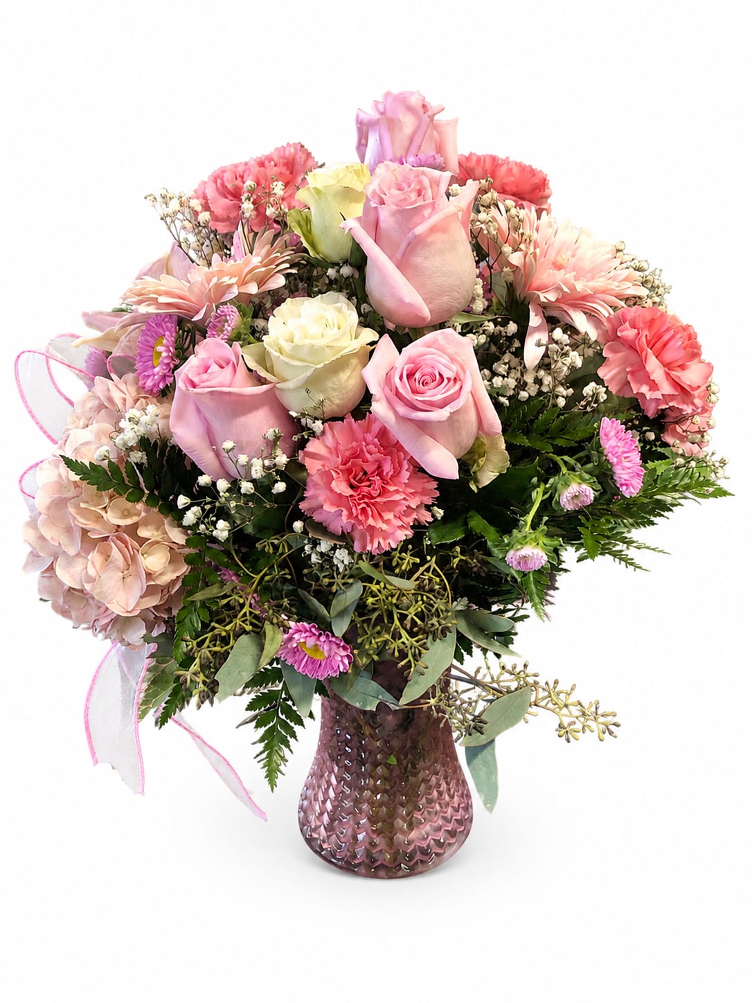 Pink and cream rose bouquet with carnations in a pink vase