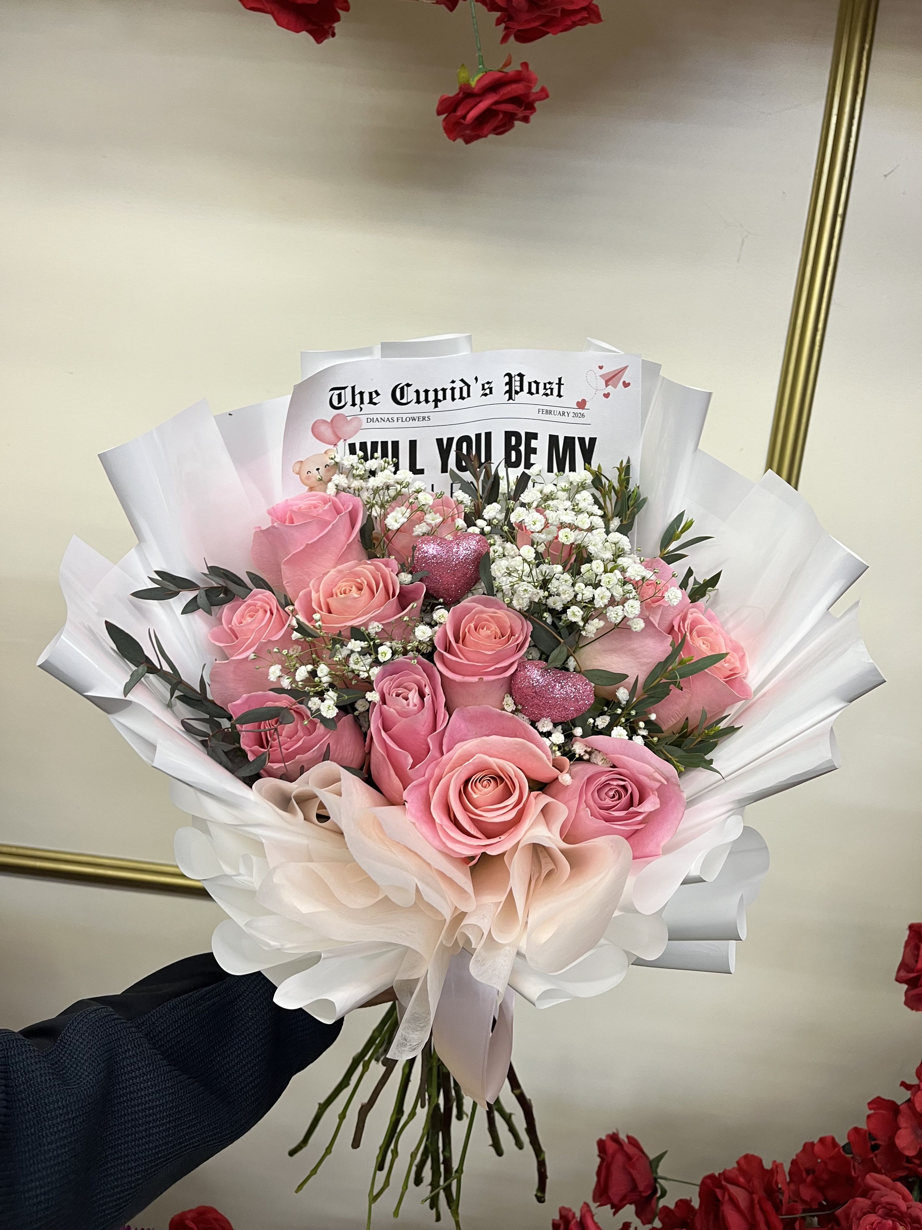 Pink rose bouquet with white baby's breath and paper wrapping