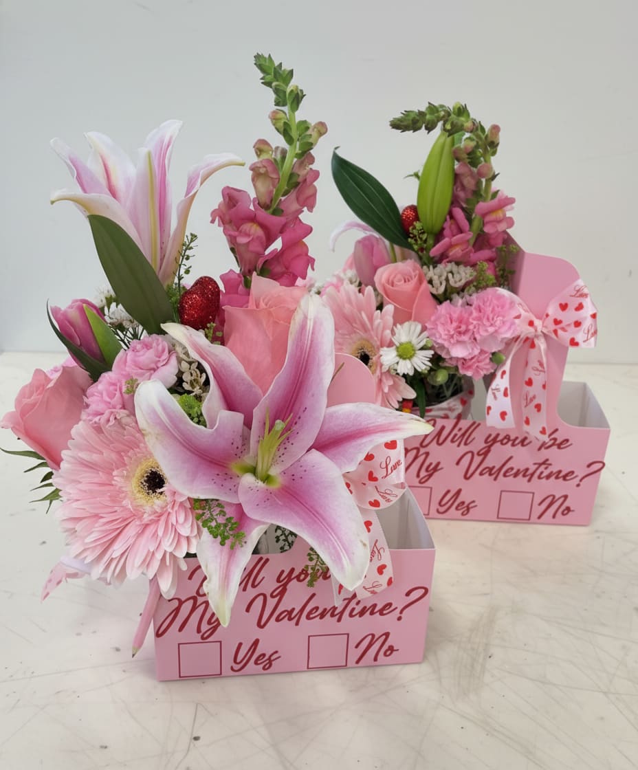Pink floral gift boxes with lilies, roses, and a Valentine message
