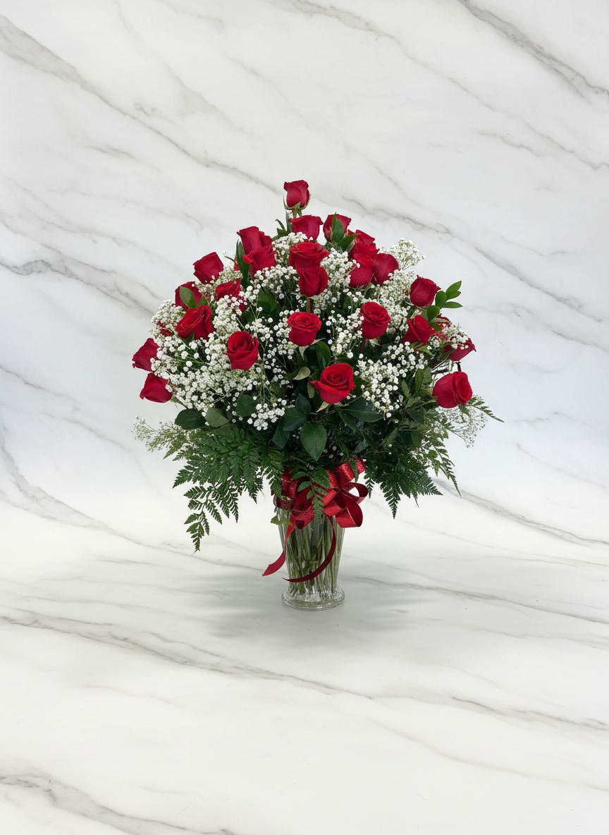 50 Rose Vase Arrangement  -  Classic red roses with white fillers in a clear vase, tied with a red ribbon-romantic, abundant arrangement perfect for anniversaries, birthdays or Valentine's Day.
