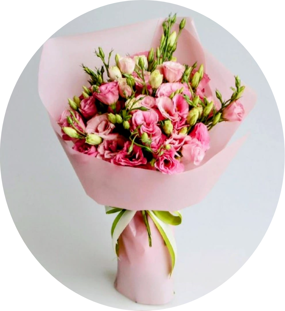 PRINCESS KALA PINK LISIANTHUS - A dramatic cluster of deep red roses rises from a sleek black square vase, creating a bold anniversary bouquet with classic romance at its heart. Tall striped tropical leaves and glossy green foliage frame the roses, giving the arrangement height and a formal, structured silhouette-the kind of gift that will make the person you're celebrating feel cherished and seen.  Soft pink and blush lisianthus bouquets offer a contrasting option for birthdays, anniversaries, or a gentle "thinking of you" moment. Tied in green ribbon and wrapped in pale pink paper, the hand-tied presentation pairs open blooms with many closed green buds for a fresh, just-gathered look that feels feminine and tender.  Choose the upright vase arrangement for a striking tabletop centerpiece or the wrapped lisianthus when you want something easy to carry and display. Both styles combine long-lasting flowers-roses or lisianthus-with sturdy greenery; for best enjoyment, refresh vase water every two days and recut stems at an angle before placing them in clean water.