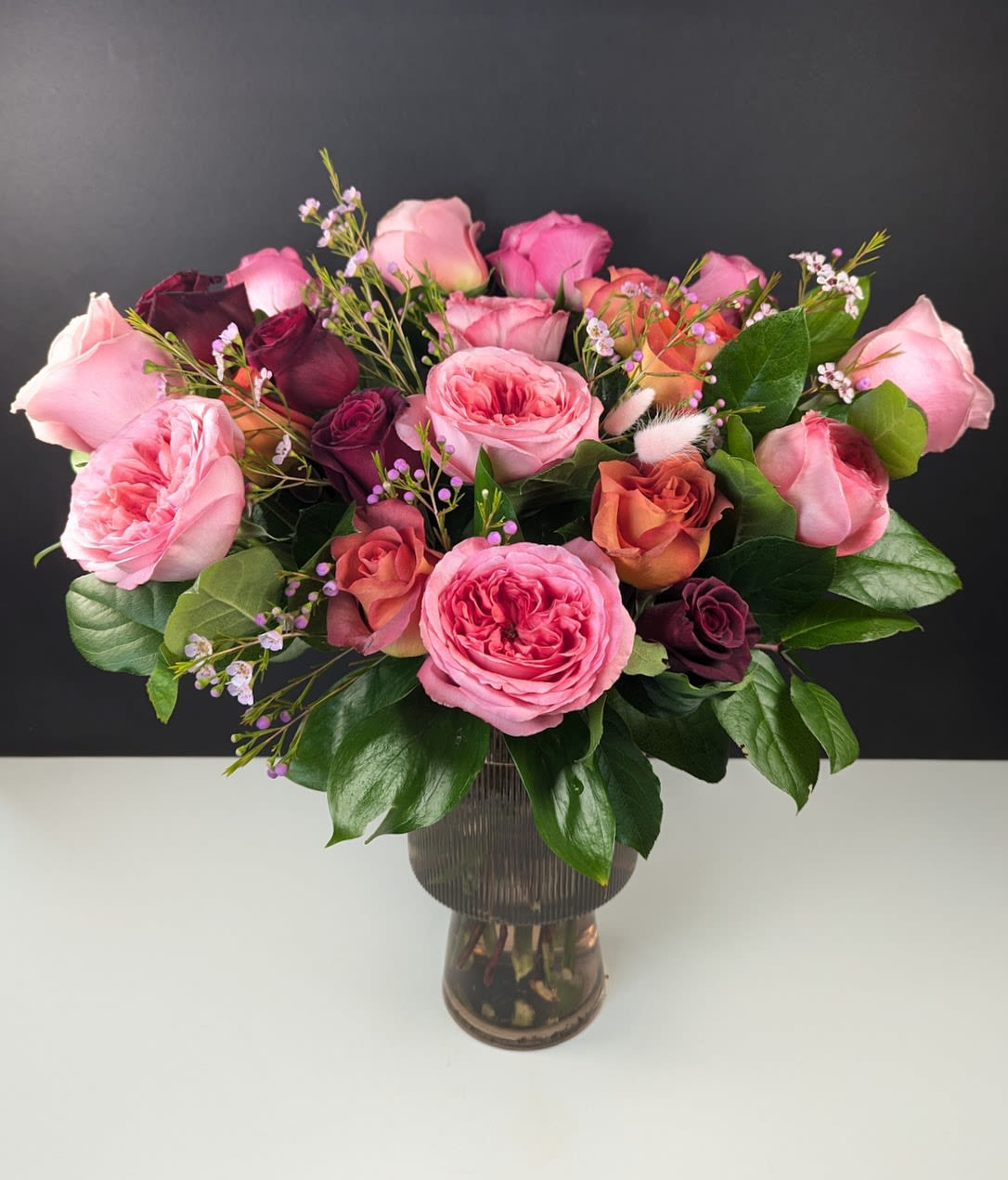 Bouquet of pink and burgundy roses in a glass vase