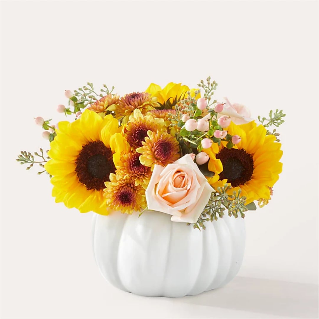 Sunflower and rose arrangement in a white pumpkin vase