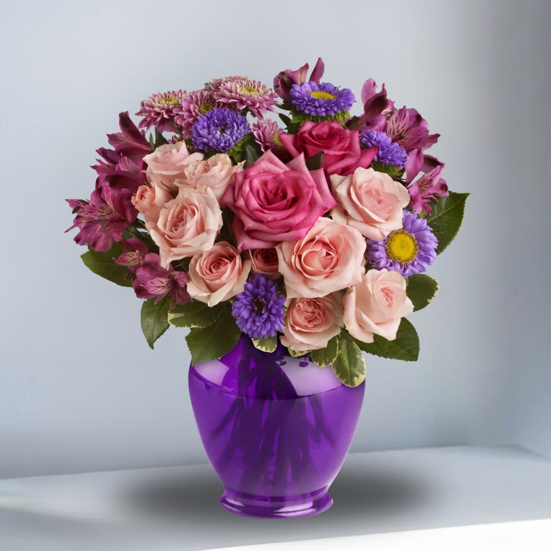 Medley of Purple with Roses - Impress someone special without depressing your budget. Send lush pink and lavender flowers in a classic purple ginger jar. 