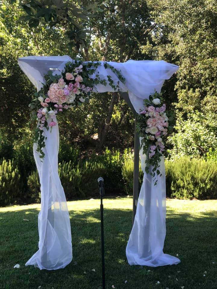 The Picturesque Arch - This 2 piece arch includes pink and purple Roses, Lisnathus, Stock Hydrangae, climbing Eucalyptus and more! Availability: All Year Round Substitution available: Yes  Must be ordered at least 5 days in advance.