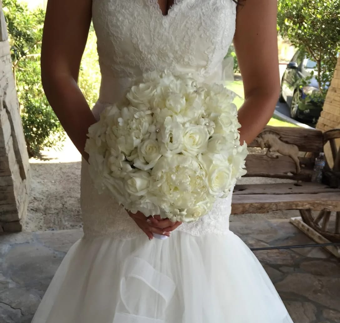 Timeless Romantic Bridal Bouquet - This traditional hand held bouquet includes Roses, Stephanotis, Seasonal Peonies, Lisianthus and Hydrangaes with crystal accents tied with ribbon. Availability: All year round Substitution available: Yes  Must be ordered at least 5 days in advance.