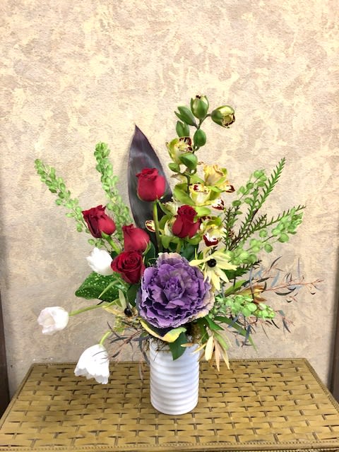 Forever and Always - Type of Flowers: Red Roses, Cymbidium Orchids, White Tulips, Cabbage, Leaves, and Tropical Greens in a tall white vase.  Availability: All year round Substitute Available: Yes Design View: Symmetric Front Facing View Photo shown: Regular 
